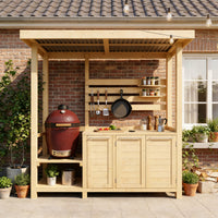 Outdoor kitchen with wooden cabinets, grill, and utensils on a brick wall background.