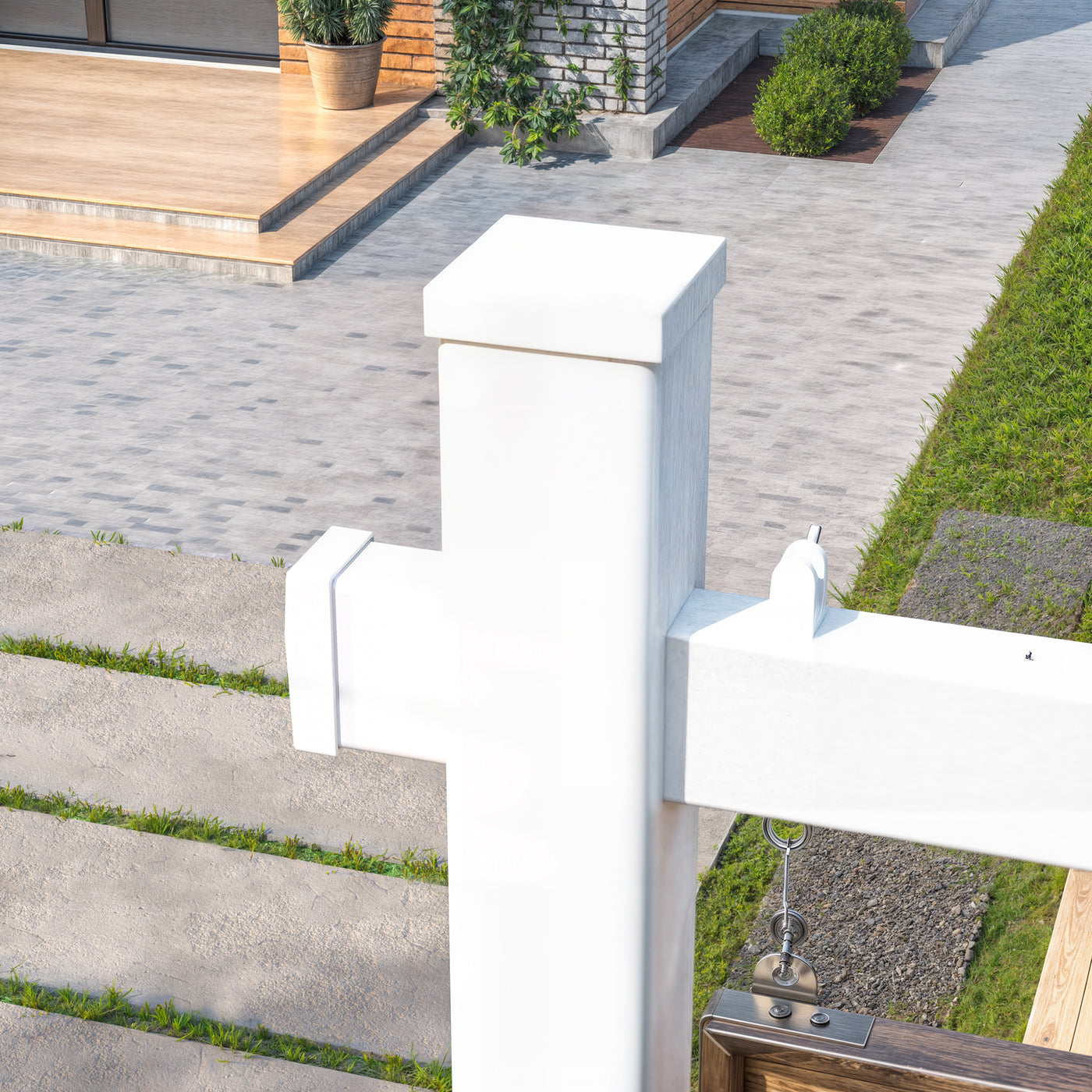 White mailbox on a post with a garden and house in the background