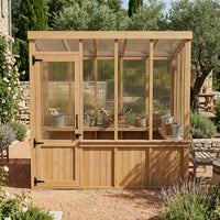 Wooden greenhouse with glass panels in a garden setting