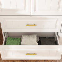 White wardrobe with gold handles in a modern bedroom setting