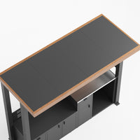 Workbench with dark gray top and storage cabinets on a white background