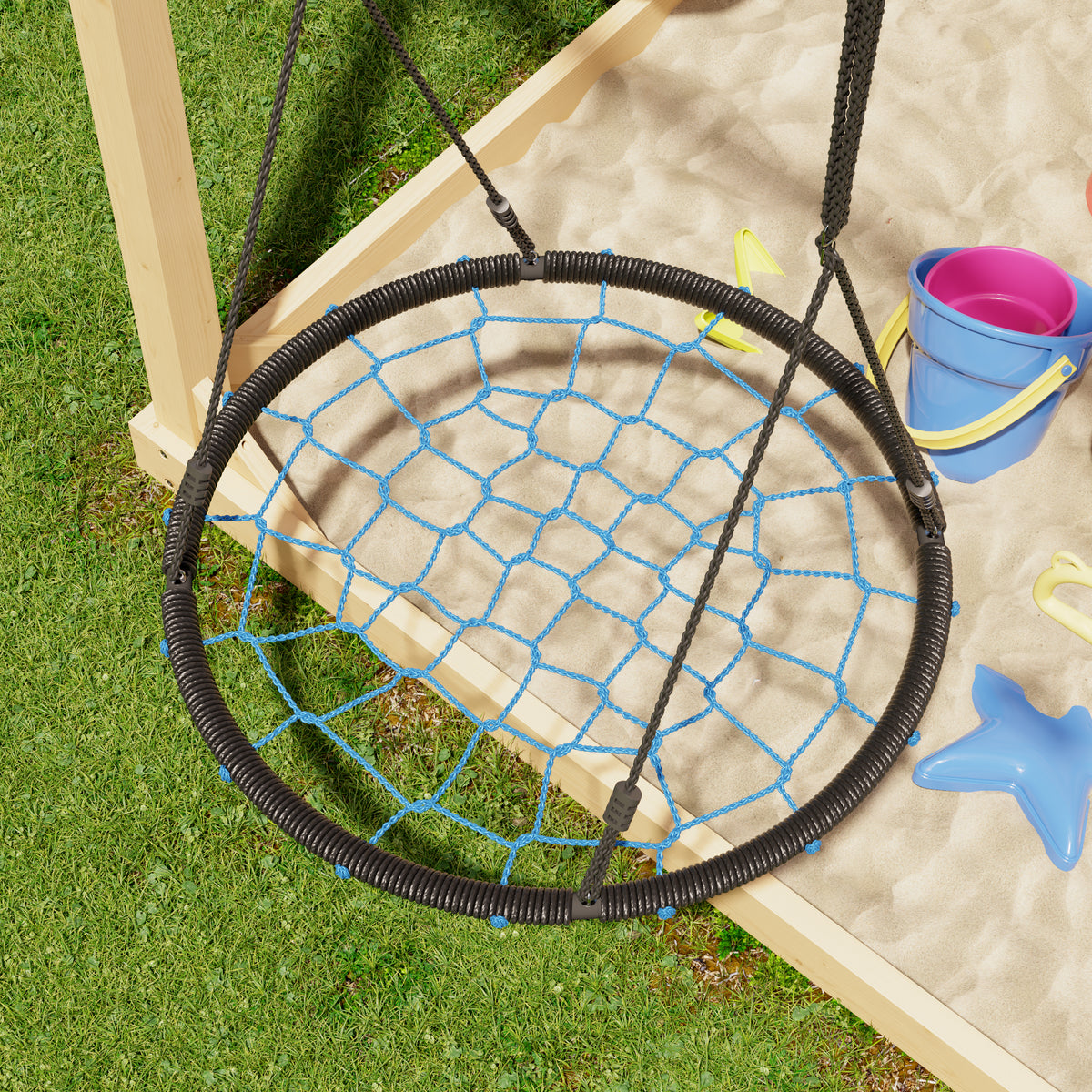 Children's swing with netting over a sandbox on grass