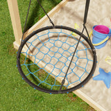Children's swing with netting over a sandbox on grass