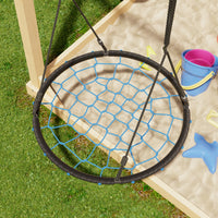 Children's swing with netting over a sandbox on grass
