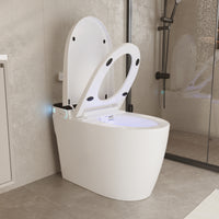 White smart toilet with open lid, built-in bidet, and ambient night light