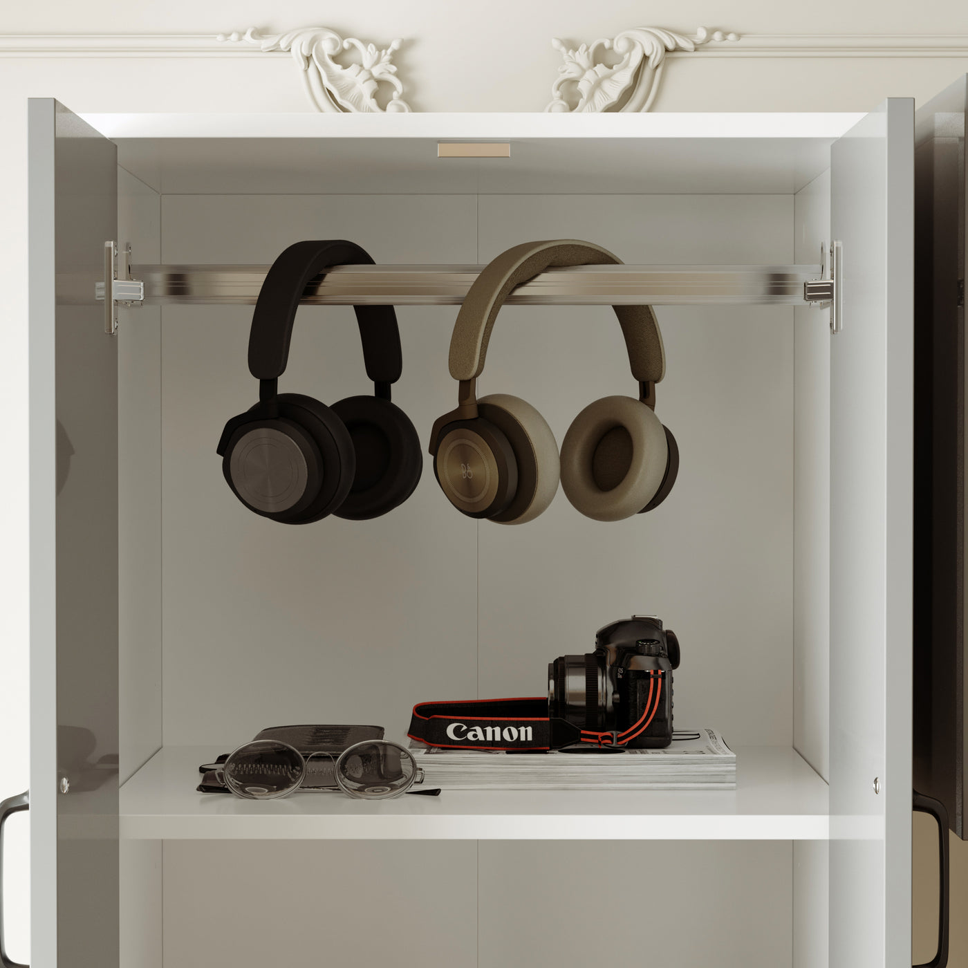 Two pairs of headphones hanging on a shelf with a camera and books below.