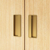 Close-up of wooden cabinet doors with gold handles