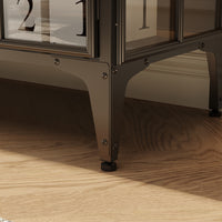 Close-up of a decorative table with glass panels on a wooden floor.