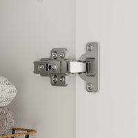 Metal cabinet hinge on a gray door with a neutral background