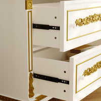 White cabinet with gold accents and open drawers on a neutral background