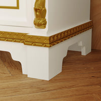 Decorative white and gold architectural element on a wooden floor