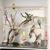 Birdcage with wooden branches, rocks, and colorful toys for birds
