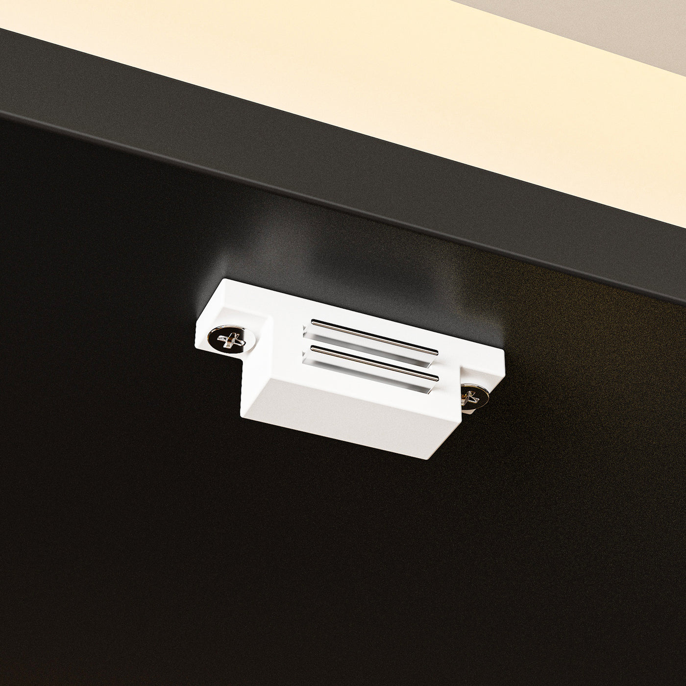 Close-up of a white ceiling light fixture on a black ceiling