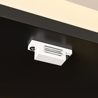 Close-up of a white ceiling light fixture on a black ceiling
