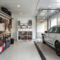 White garage storage cabinet with countertop, tool wall, and lower doors