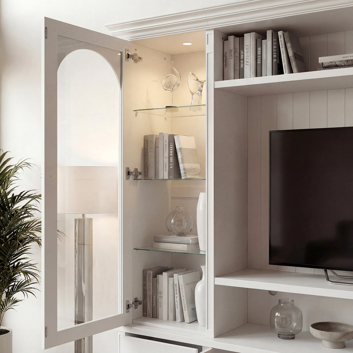 White entertainment center with open TV space, glass side cabinets, lower storage cabinets, and drawers