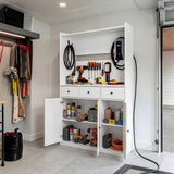 White garage storage cabinet with countertop, tool wall, and lower doors