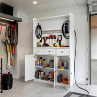 White garage storage cabinet with countertop, tool wall, and lower doors