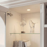 White entertainment center with open TV space, glass side cabinets, lower storage cabinets, and drawers