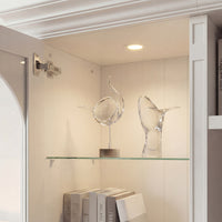 White entertainment center with open TV space, glass side cabinets, lower storage cabinets, and drawers