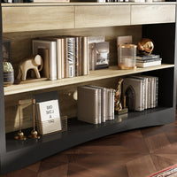 Decorative shelf with books, a lamp, and other items on a wooden floor.