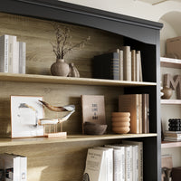 Bookshelf with decorative items including books, vases, and a small plant.